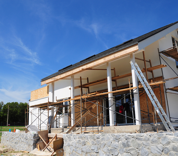 House under construction with scaffolding outside.