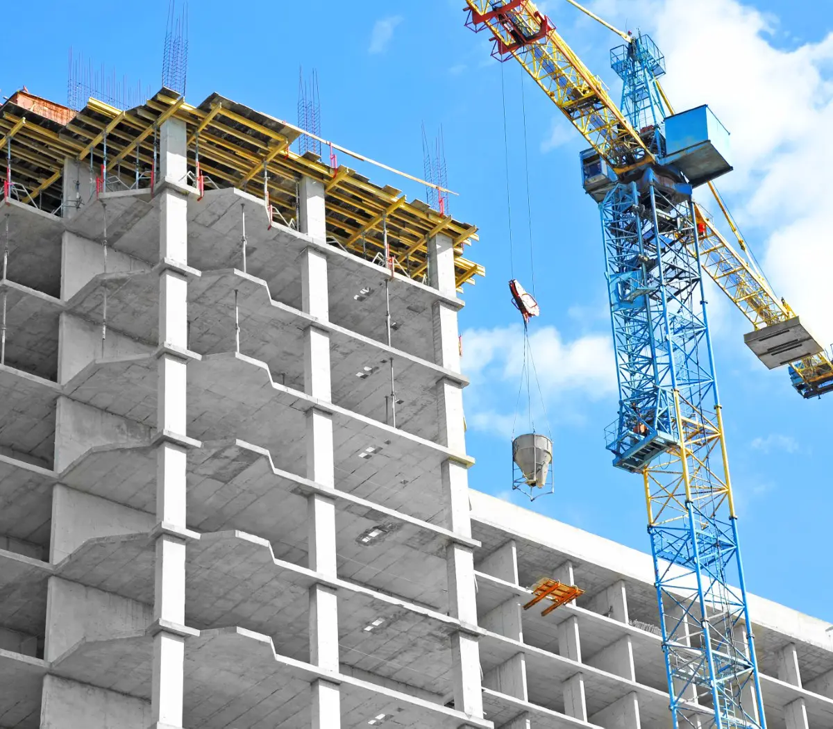 Building under construction with crane nearby.